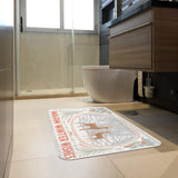 Winter doormat with deer and "Warm Winter Wishes" in a bathroom. Rubber floor mat for entryway or bathroom.