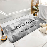 Coral velvet bath rug with "The Adventure Never Ends" design, perfect for bathroom use.