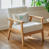 Customizable golden velvet throw pillow case on a cream armchair in a living room, featuring 'YOUR DESIGN HERE' text