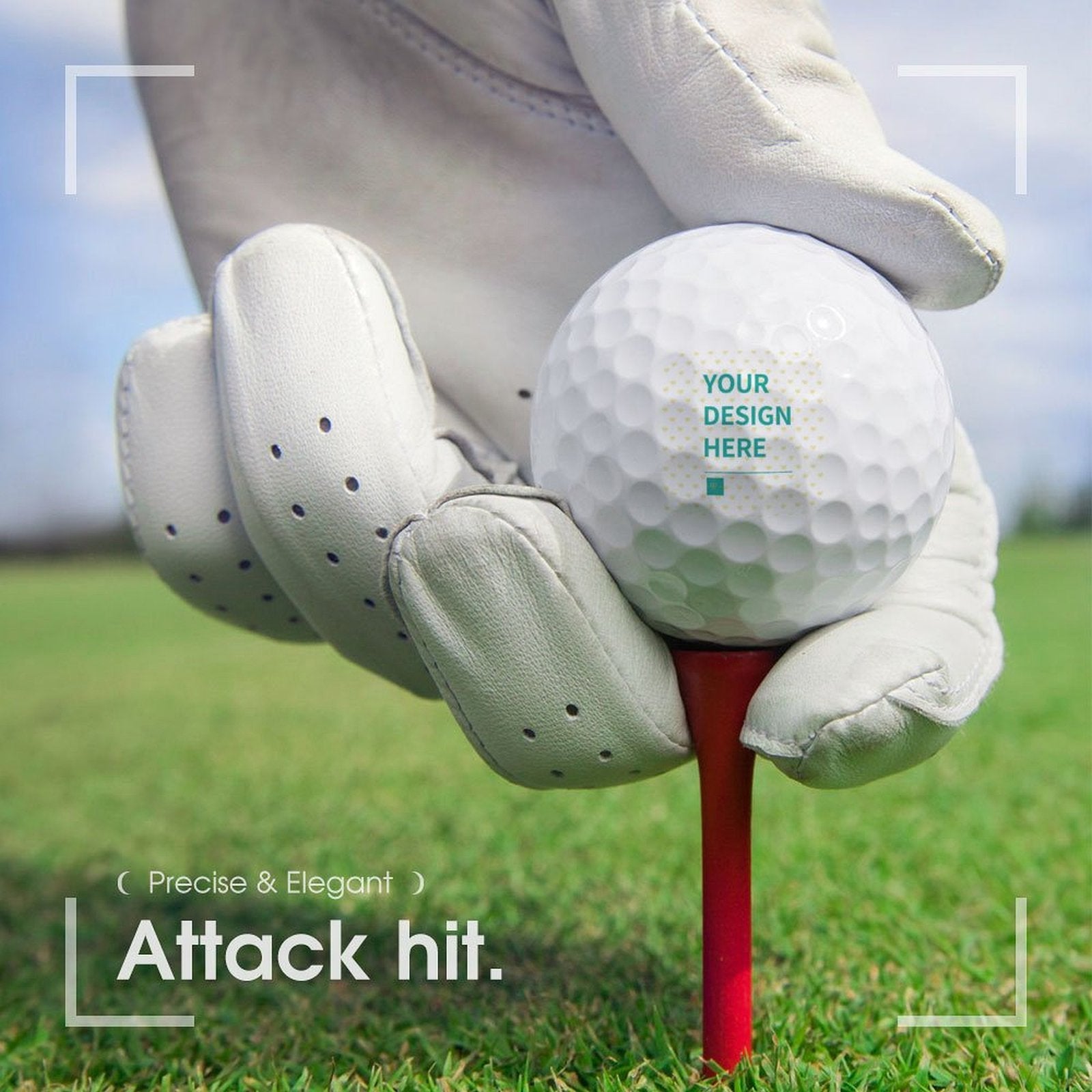 Personalized golf ball with space for custom design, held by gloved hand on a red tee, "Attack Hit!"