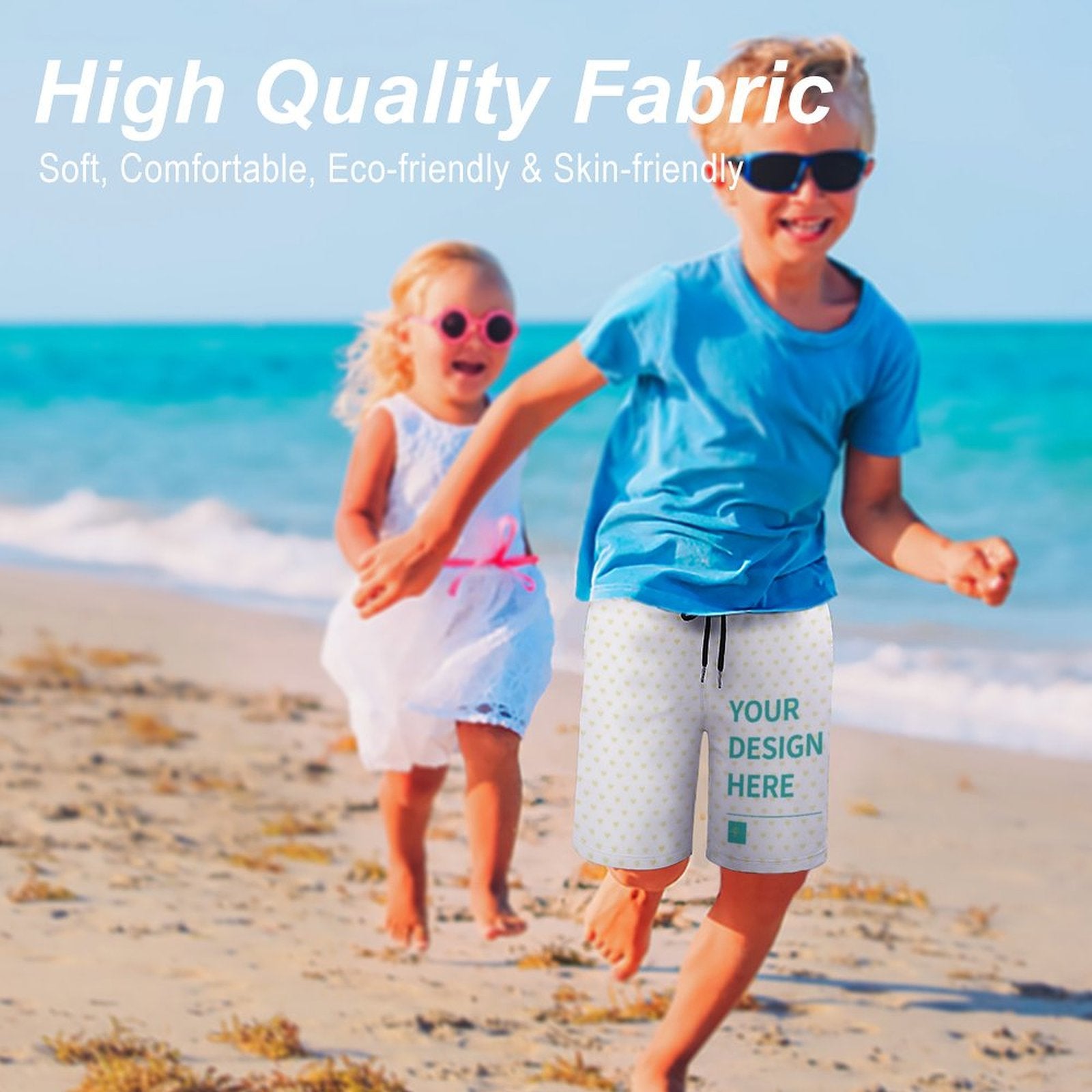 Custom kids swim trunks with 'YOUR DESIGN HERE' on beach, featuring high-quality, soft, eco-friendly fabric
