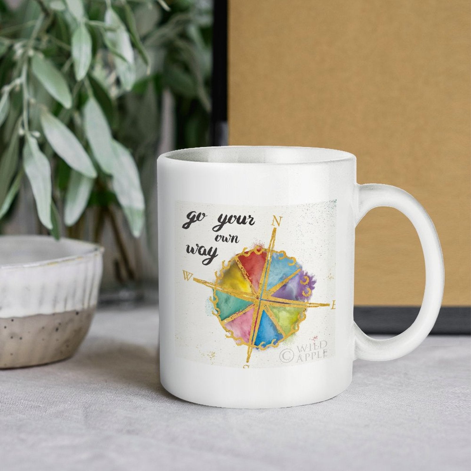 White ceramic mug with "Go Your Own Way" and compass rose design. Personalized gift for home or office use.