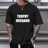 Black Gildan TROPHY HUSBAND T-shirt, comfortable cotton tee for casual wear and gifting.