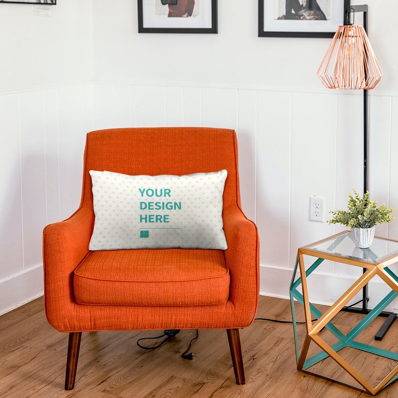 Personalized throw pillow with 'YOUR DESIGN HERE' text on an orange armchair, custom design for sofa or bed.