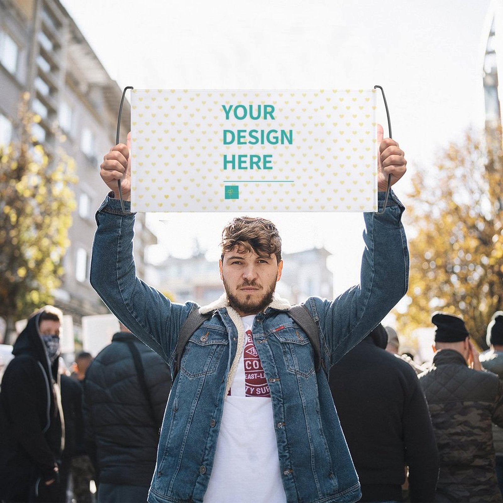 Custom hand waving flag with "YOUR DESIGN HERE" design, held by a man in a crowd, cheering and support