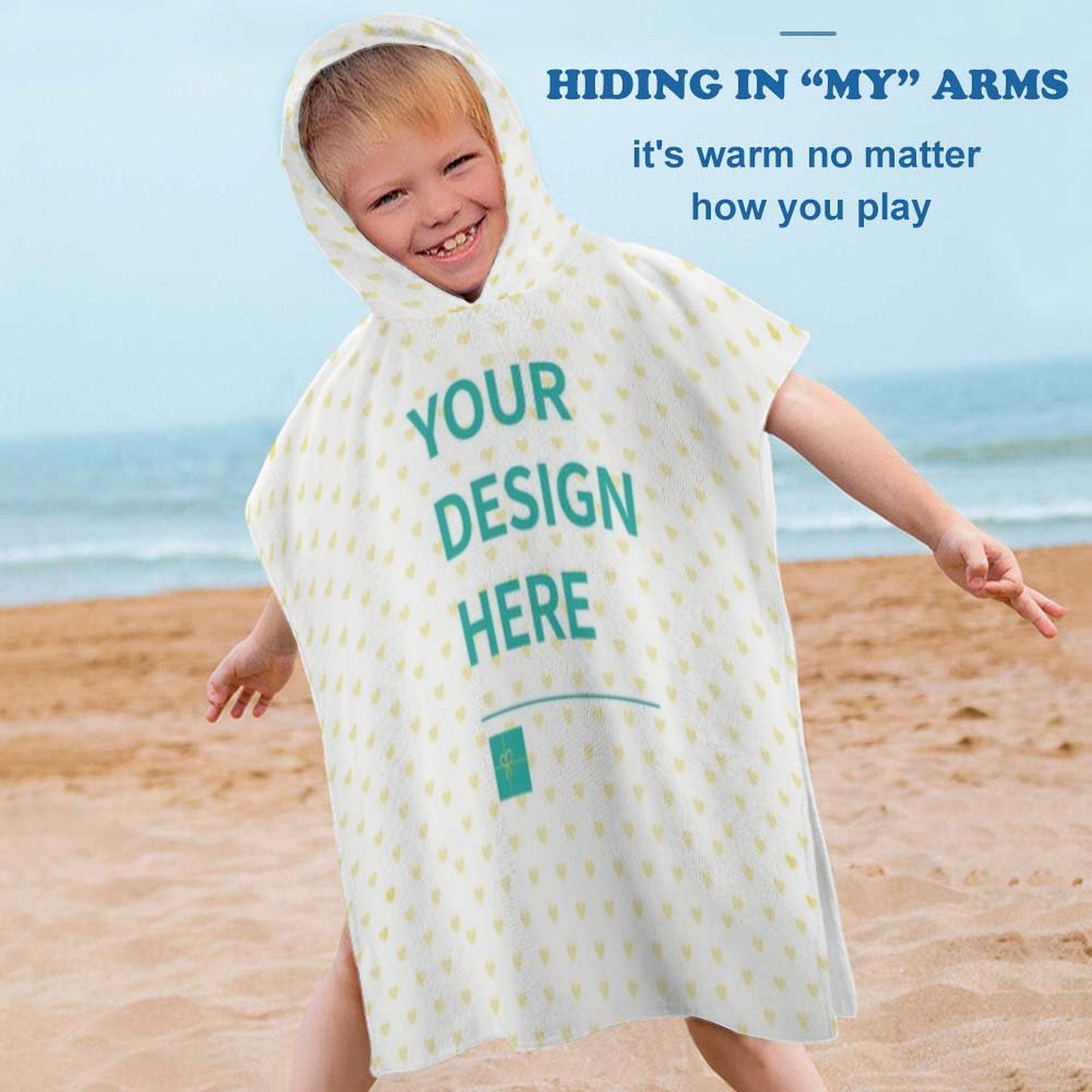 Custom baby hooded towel with 'YOUR DESIGN HERE' on the beach. Soft, absorbent towel for kids, beach, bath or pool.
