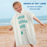 Custom baby hooded towel with 'YOUR DESIGN HERE' on the beach. Soft, absorbent towel for kids, beach, bath or pool.