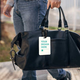 Custom luggage tag on a black bag; features 'YOUR DESIGN HERE' text, made of TPU material; perfect for travel