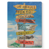 Tourist guide sign metal wall decor featuring Los Angeles, Tokyo, New York, and other international destinations