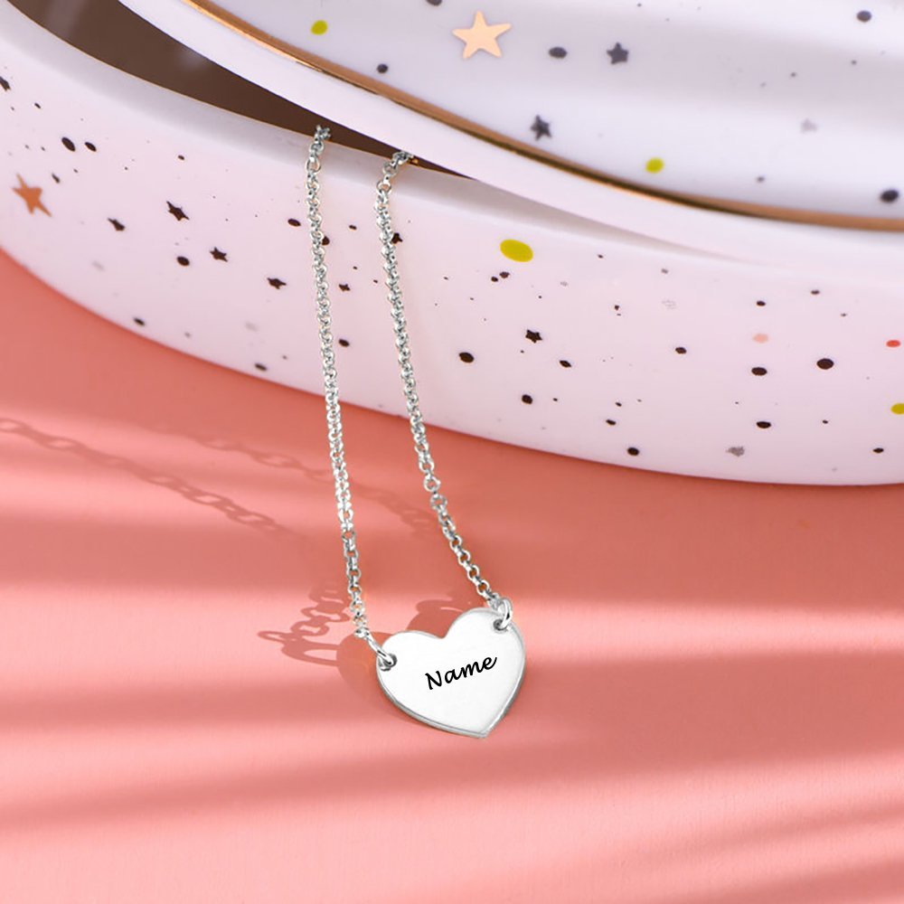 Personalized silver heart necklace with engraved name, a perfect custom jewelry gift.