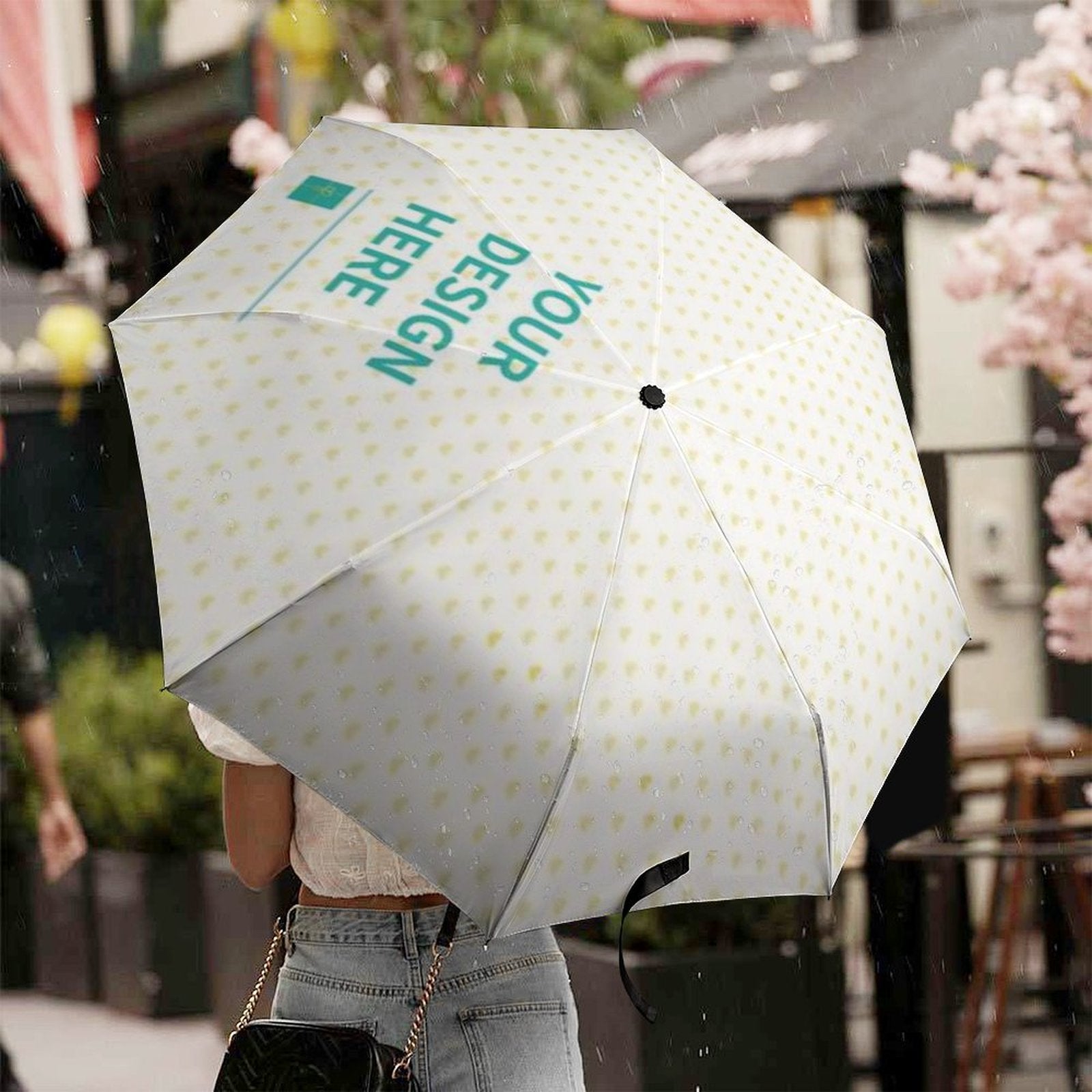 Customizable 3-fold umbrella with 'Your Design Here' design, UV resistant, and windproof.