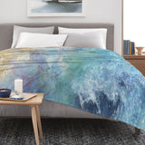 Blue ocean wave flannel blanket on bed, soft and cozy, perfect for sofa or couch