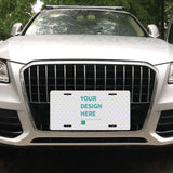 Customizable aluminum license plate with "YOUR DESIGN HERE" design on front of a car, waterproof and rust-resistant.