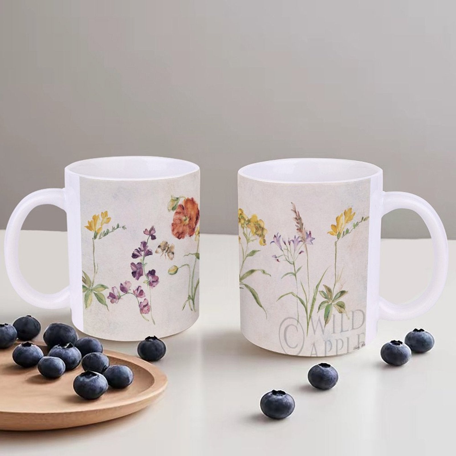 White ceramic mug with watercolor wildflower design, perfect gift for home or office, Wild Apple brand.