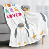 Penguin flannel blanket with "YOU ARE LOVED" text. Super soft, cozy kids' bedding.