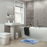 Blue whale watercolor bath rug in a modern bathroom. Non-slip coral velvet floor carpet for bathroom or kitchen decor.