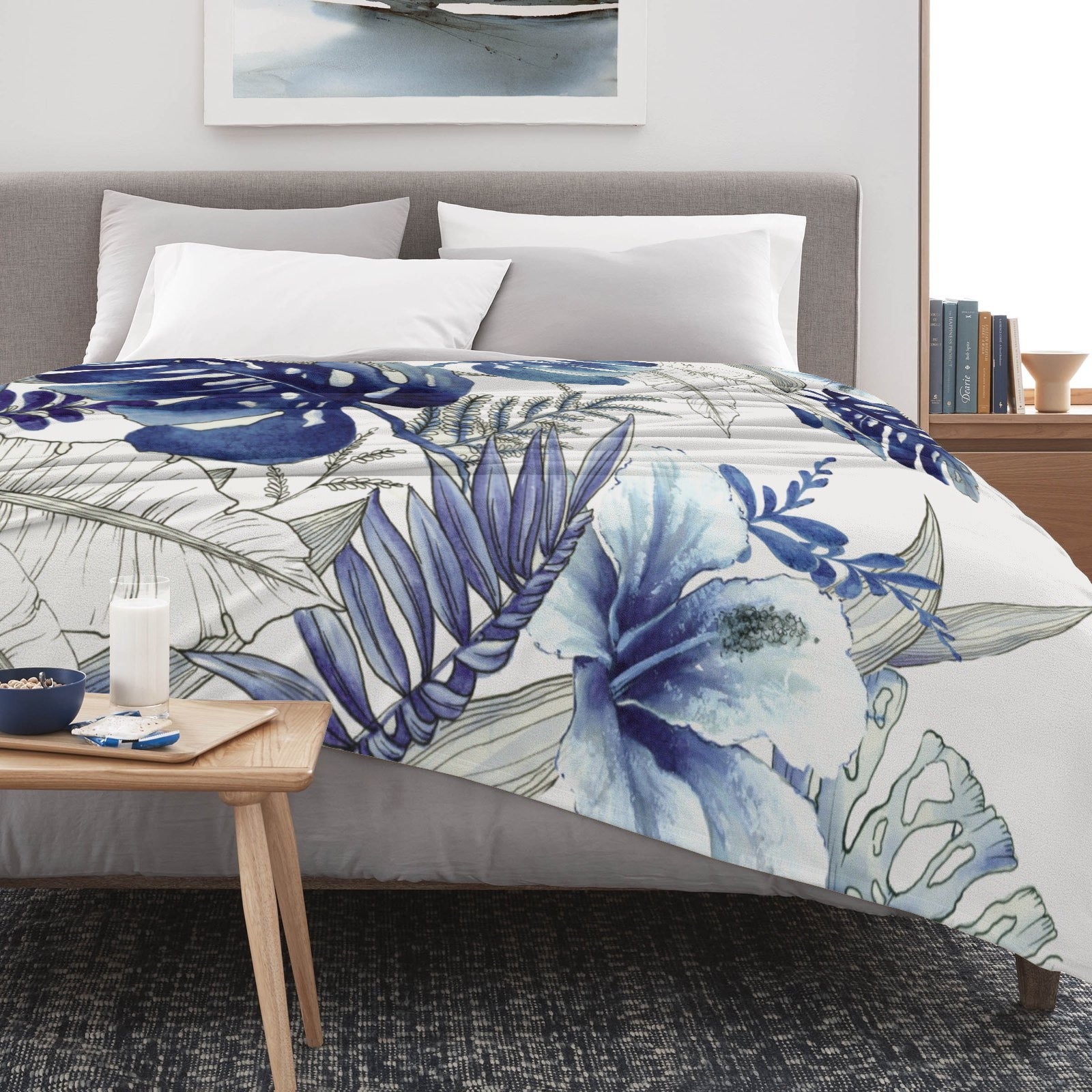Blue tropical plants flannel blanket made in USA on bed, watercolor design