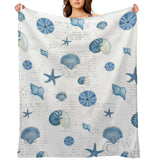 Navy shells pattern fleece blanket featuring blue seashells and starfish, soft and cozy for bed or sofa