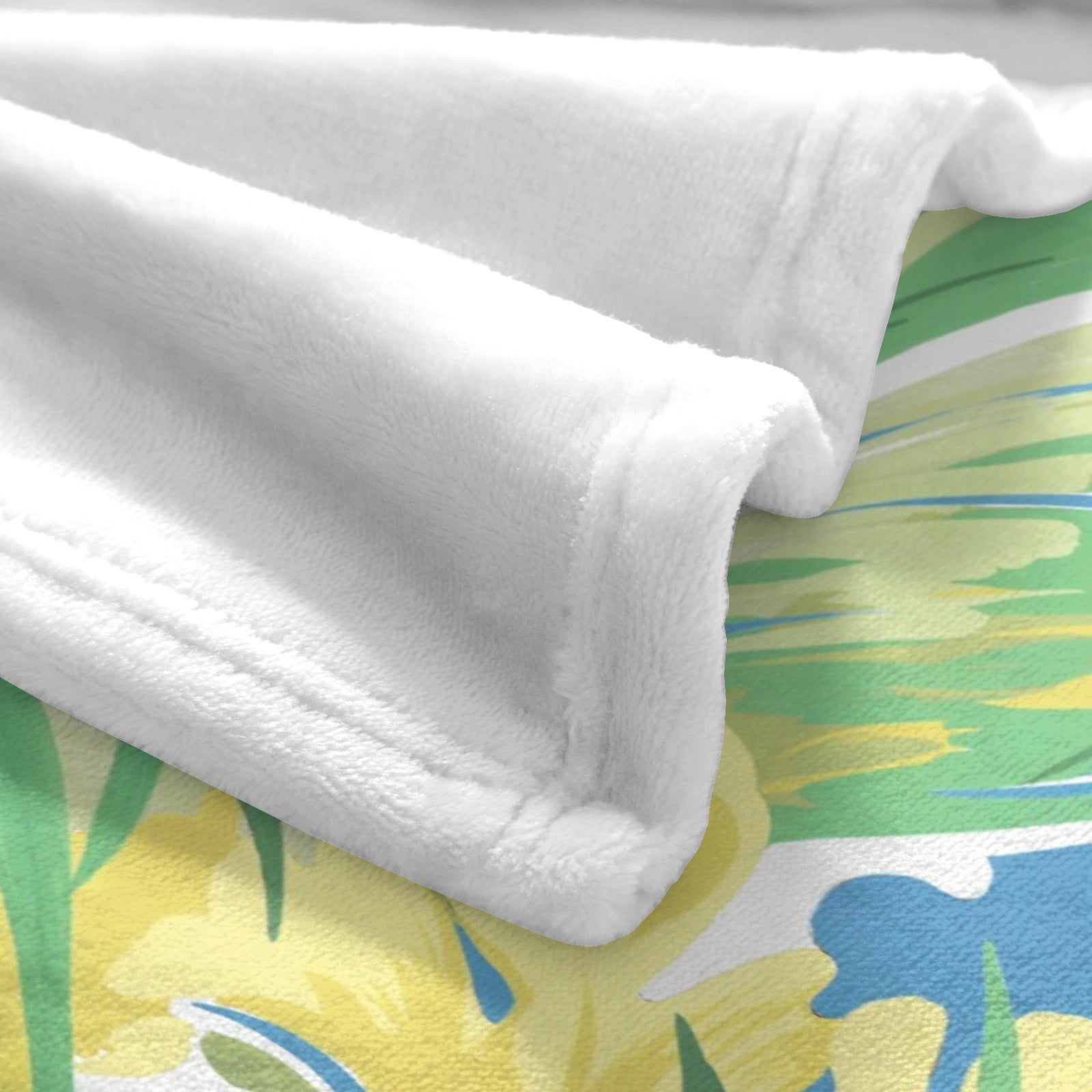 White Flannel Blanket with Green Tropical Plants Design. Soft, cozy, and ideal for couch or bed decor.