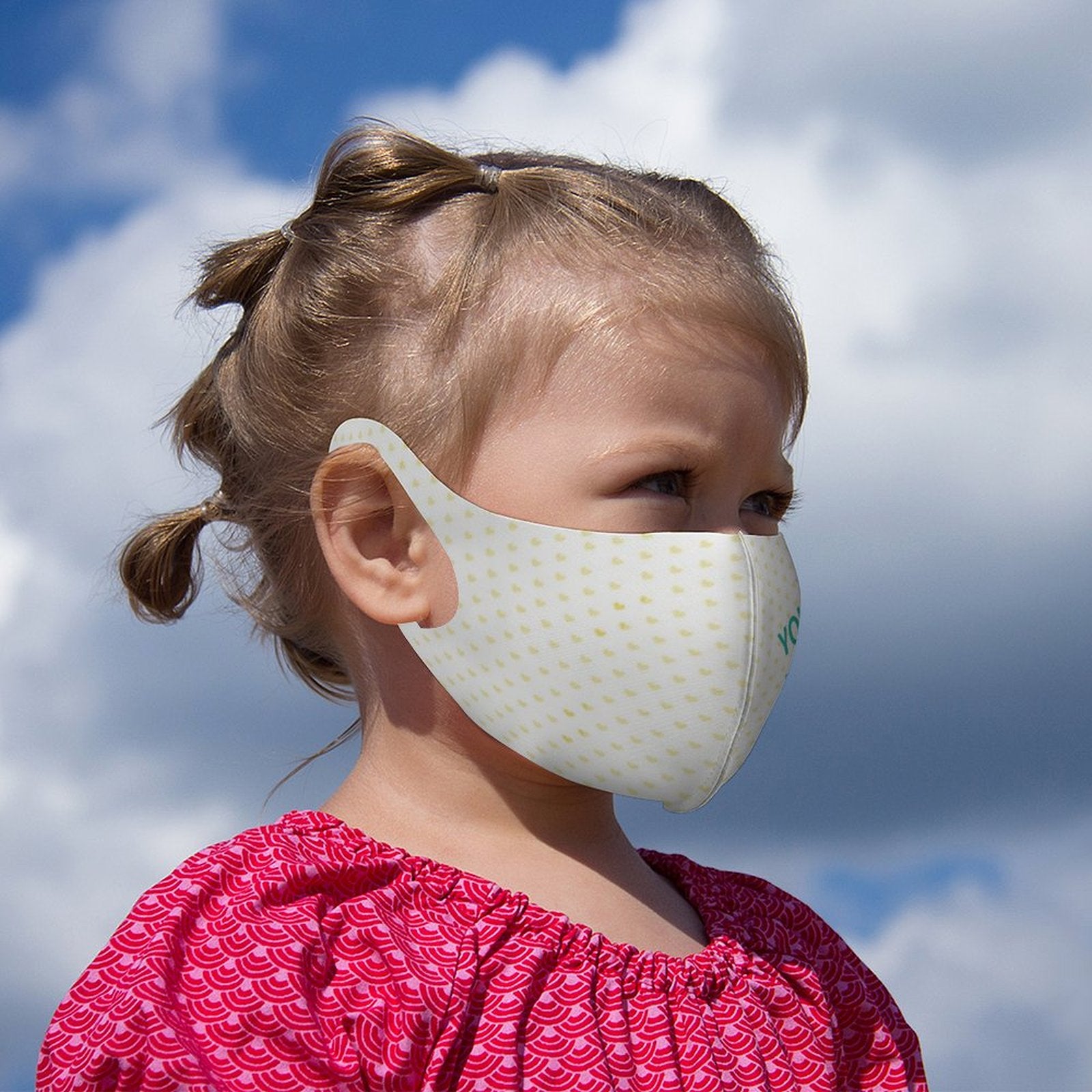 Reusable kids mask with heart pattern. Breathable face cover for sports and outdoor activities. Personalized design.