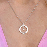 Personalized silver circle necklace for women, diamond pendant, custom engraved text 'Your Name', on a silver chain.