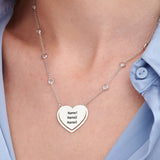 Personalized silver heart puzzle necklace with engraved names. Custom couple gift.