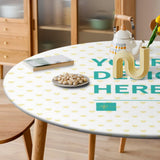 Customizable round tablecloth with design, perfect for dining or patio. Features "Your Design Here" with heart pattern.