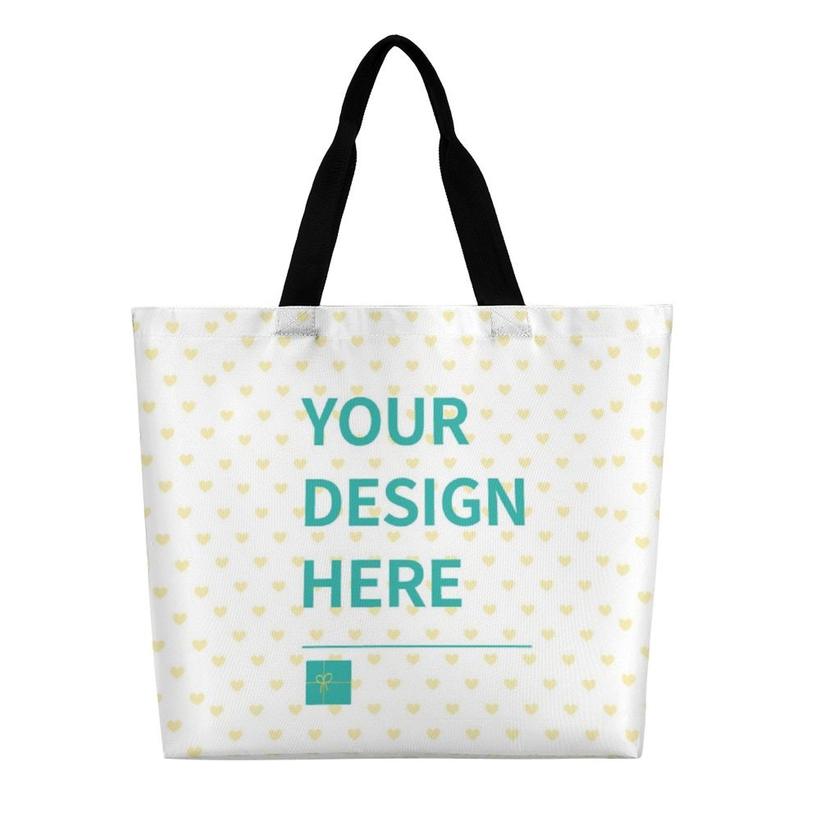Customizable canvas tote bag with "YOUR DESIGN HERE" text, heart pattern, black handles, perfect for gifts.