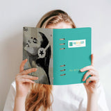 MyArtsyGift teal loose-leaf notebook held by a person, featuring an art print and 'From Art to Everything'