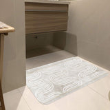 Beige rubber floor mat with abstract white wave design in bathroom setting