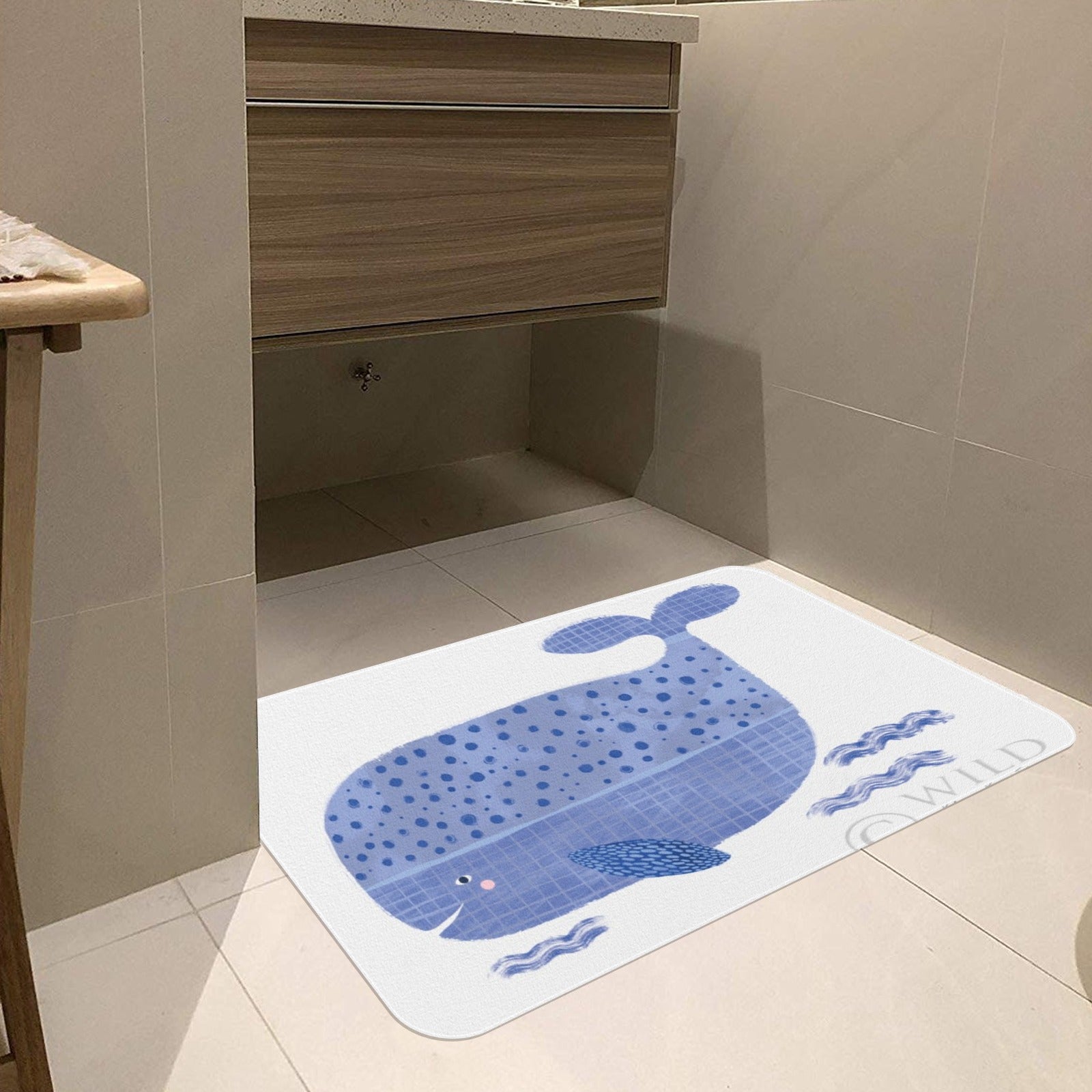 Blue whale bathroom mat, white mat with whale illustration and wild text.