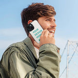 Custom iPhone 15 flip case with YOUR DESIGN HERE text, PU leather, and card slot design, held by a smiling man.
