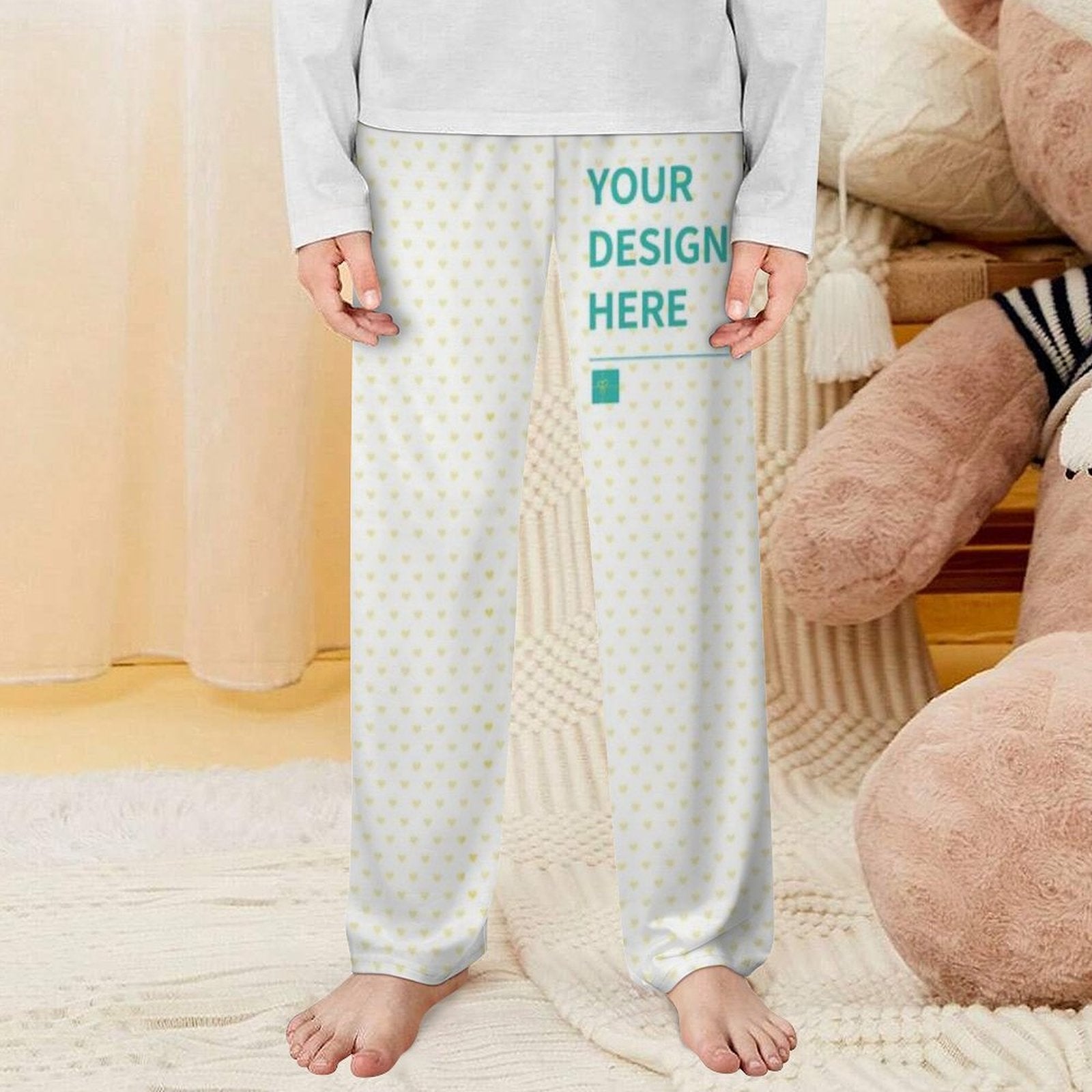 Personalized pajama pants for toddler with heart pattern and "YOUR DESIGN HERE" design text.