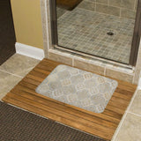 Coral velvet bath rug with gold floral pattern on wooden bath mat, perfect for bathroom decor