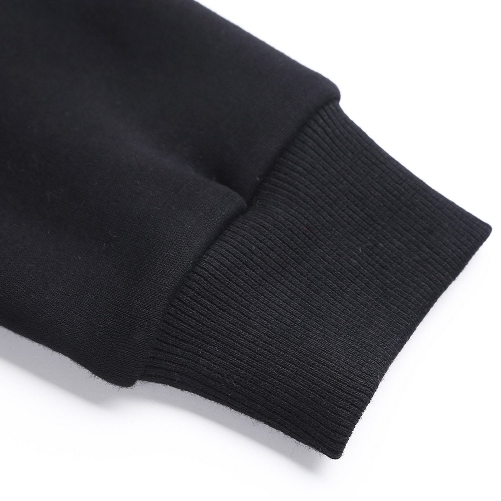 Black youth hoodie detail: ribbed cuff and cotton fabric. Customizable youth sweatshirt, comfortable fit.