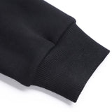 Black youth hoodie detail: ribbed cuff and cotton fabric. Customizable youth sweatshirt, comfortable fit.