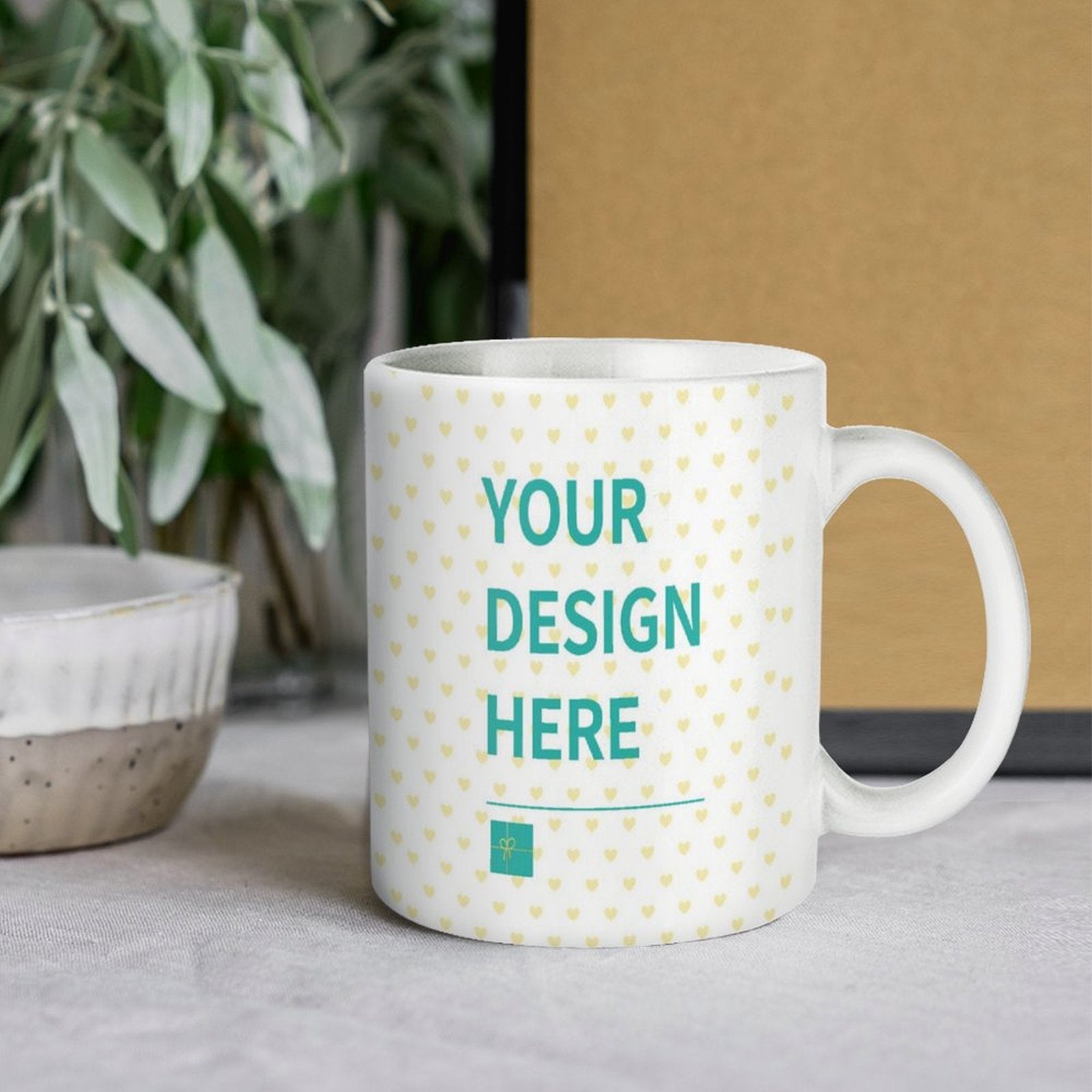 Customizable white ceramic mug with "YOUR DESIGN HERE" text, perfect personalized gift