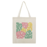 Personalized Canvas Tote Bag with colorful Monstera leaf pattern, made of cotton, perfect for shopping.