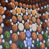 Close-up of handmade mosaic artwork. Featuring colorful paint dots on linen canvas by Ben Heine, wall art.