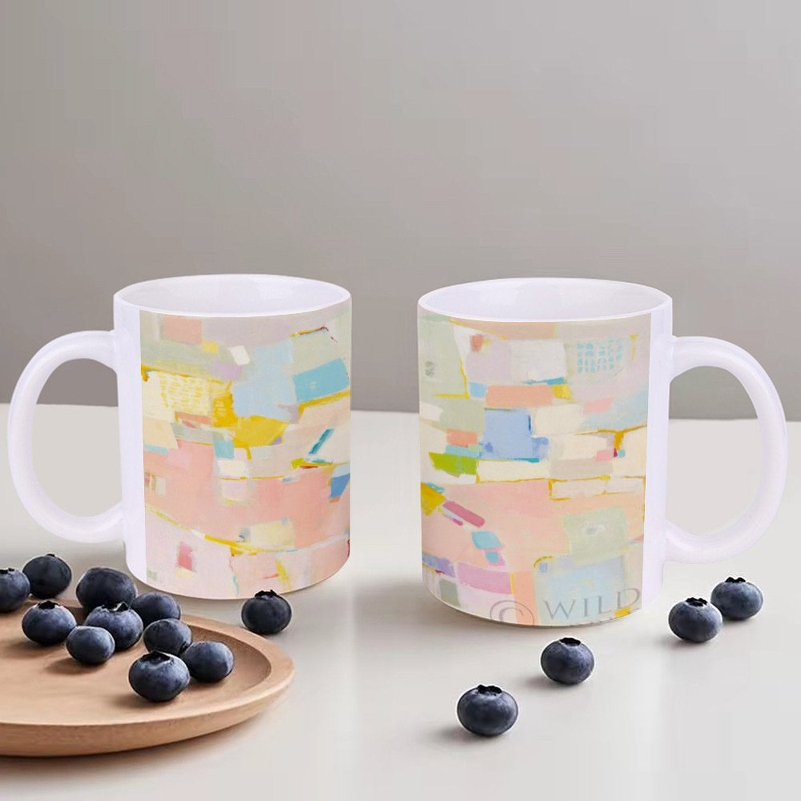 White ceramic mug with colorful abstract art design with 'WILD' text, perfect gift with blueberries