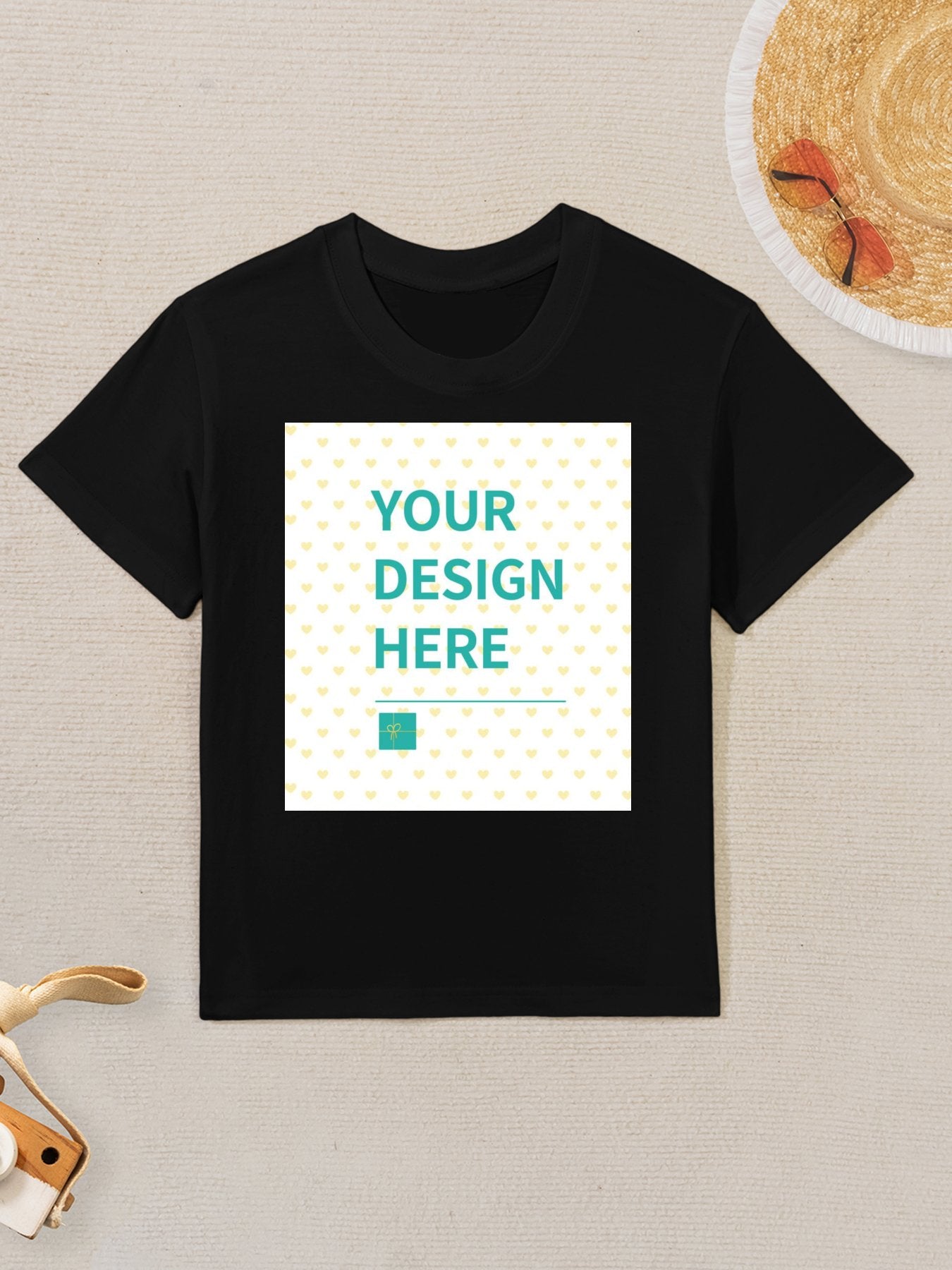 Customizable black cotton kids t-shirt with "YOUR DESIGN HERE" text for personalized design.