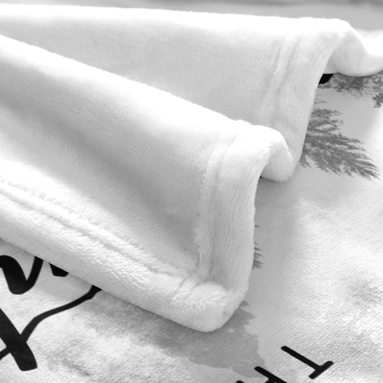 Black and white misty forest fleece blanket detail, soft polyester material.