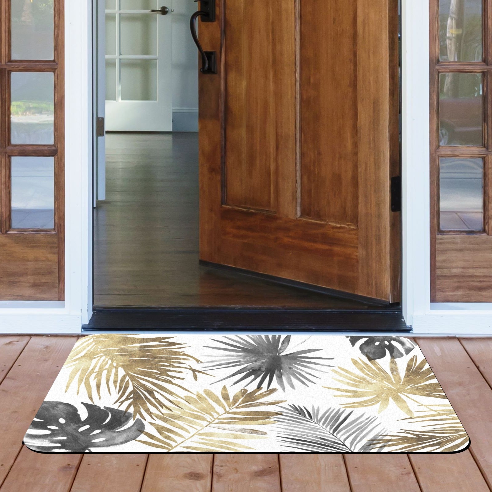 Tropical leaves entrance doormat in gold and gray with wooden door.
