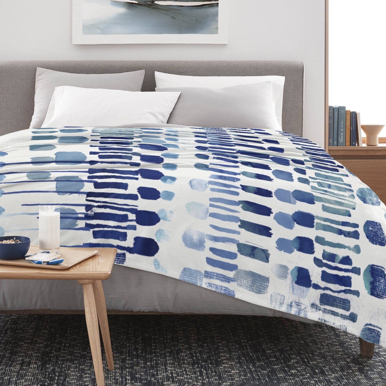 Modern blue abstract flannel blanket on bed, perfect for sofa, couch and bed. Made in USA, soft and cozy design.