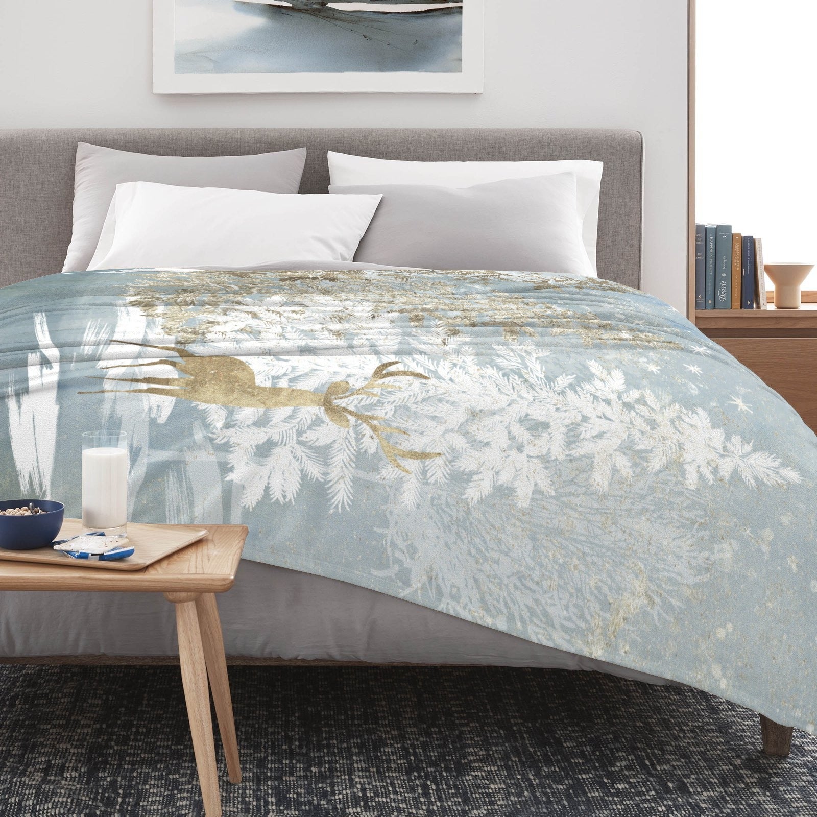 Blue Winter Forest Deer Flannel Blanket on bed. Soft and warm, perfect for sofa or bed, made in USA