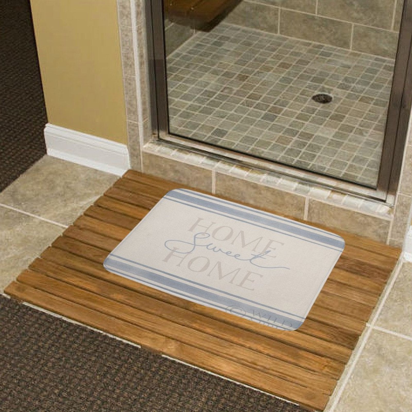 Bathroom rug with HOME Sweet HOME text on wooden slat floor, non-slip