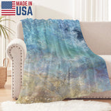 Blue ocean wave flannel blanket on sofa, Made in USA, perfect for bed or couch