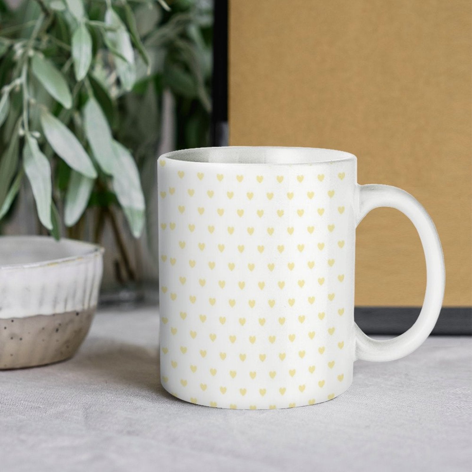 White ceramic mug with yellow heart pattern. A perfect personalized gift for expressing love and warmth.