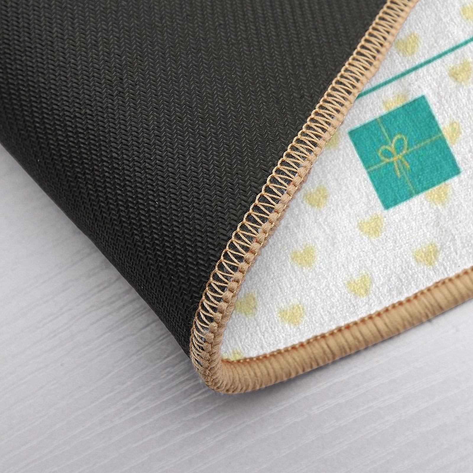 Custom washable floor mat detail with non-slip backing, heart pattern and gift box design.