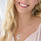 Personalized silver heart pendant necklace with custom engraving on a woman